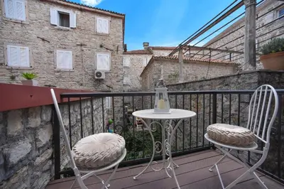 two chairs and a table on a balcony at OLD TOWN Budva apart 3 with balcony in Budva