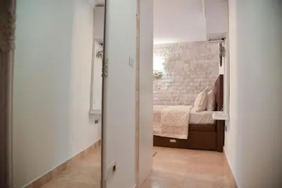 a room with a bedroom with a bed and a mirror at OLD TOWN Budva apart 3 with balcony in Budva