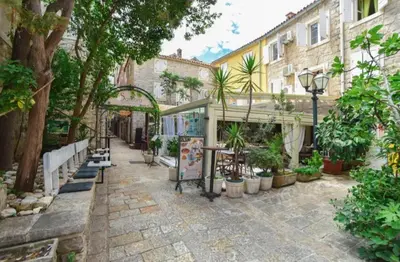 a patio with a bunch of plants and a building at OLD TOWN Budva apart 3 with balcony in Budva