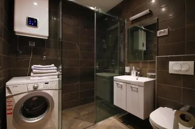a bathroom with a washing machine and a sink at Apartments Dangubic in Petrovac na Moru