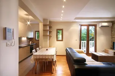 a living room with a table and a couch at Apartments Dangubic in Petrovac na Moru