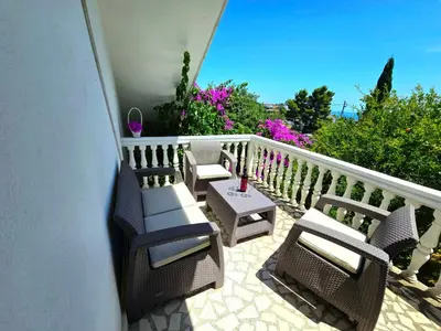 a patio with chairs and a table on a balcony at Apartment Dragovic in Ulcinj