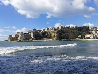 a view of a city from the beach with waves at Apartment Dragovic in Ulcinj