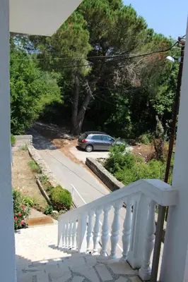 a white stairway with a car parked on a street at Apartment Dragovic in Ulcinj