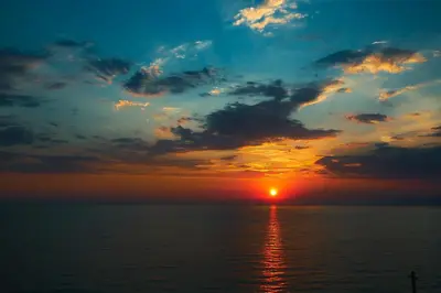 a sunset over a body of water at Sunset Bay Apartments in Utjeha
