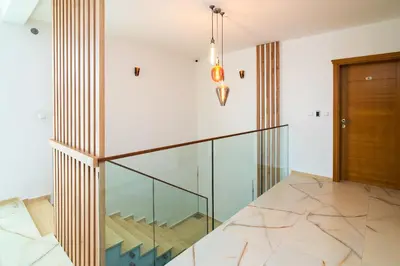 a glass staircase in a house at Sunset Bay Apartments in Utjeha