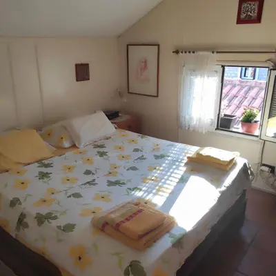 a bedroom with a bed with towels on it at Guesthouse Bogdanovic in Budva