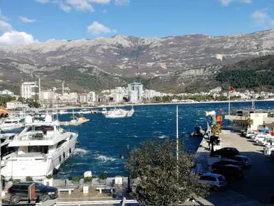 a group of boats docked in a harbor with mountains at Guesthouse Bogdanovic in Budva