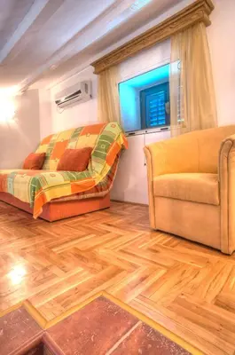 a living room with a bed and a couch at Holiday Home Neda in Sveti Stefan