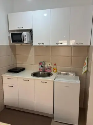 a small kitchen with a sink and a microwave at Studio 23 in Podgorica