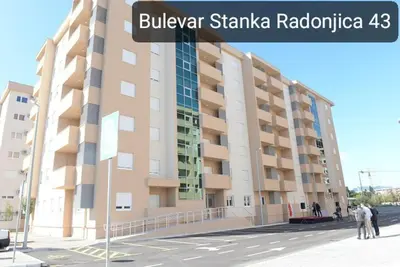 a large building on a street with a street sign at Studio 23 in Podgorica
