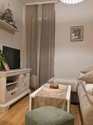 a living room with a couch and a tv at Podgorica apartment in Podgorica