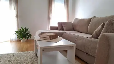 a living room with a couch and a white table at Podgorica apartment in Podgorica