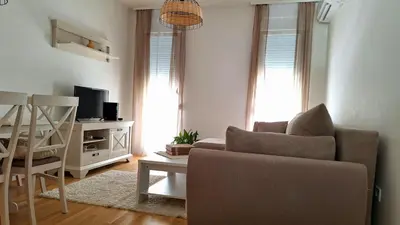 a living room with a couch and a television at Podgorica apartment in Podgorica
