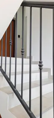 a staircase with black railings and white stairs at Podgorica apartment in Podgorica