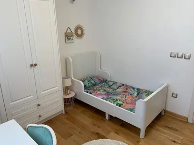 a white crib in a room with a childs bedroom at Alex Apartments in Budva