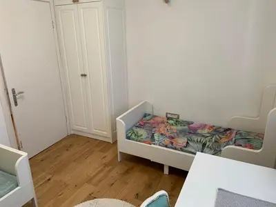 a small room with a bed with a comforter at Alex Apartments in Budva