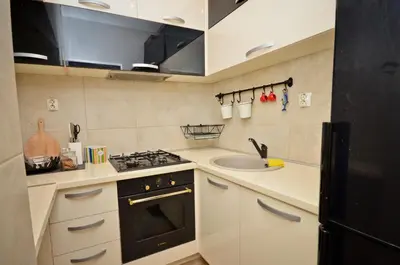 a small kitchen with a stove and a sink at Alex Apartments in Budva