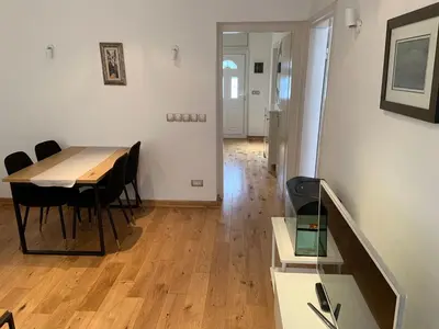 a dining room with a table and chairs in a room at Alex Apartments in Budva