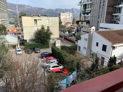 a group of cars parked in a parking lot at Alex Apartments in Budva