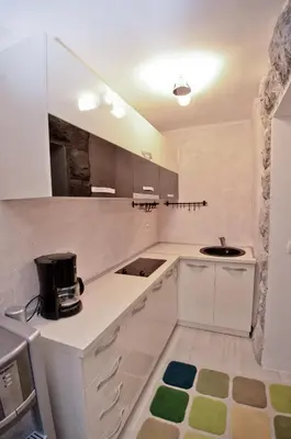 a kitchen with white cabinets and a sink at Alex Apartments in Budva