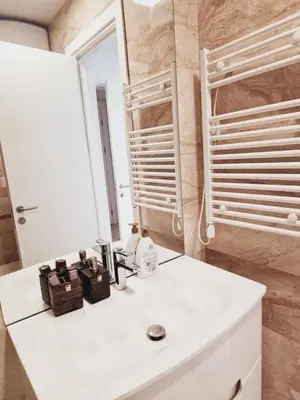 a bathroom with a white sink and a mirror at Luxury 3 bedroom private apt in beachfront Hotel in Budva