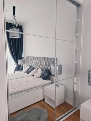 a mirror in a bedroom with a bed with pillows at Luxury 3 bedroom private apt in beachfront Hotel in Budva