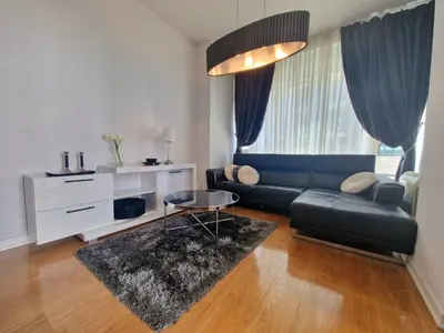 a living room with a couch and a table at Luxury 3 bedroom private apt in beachfront Hotel in Budva