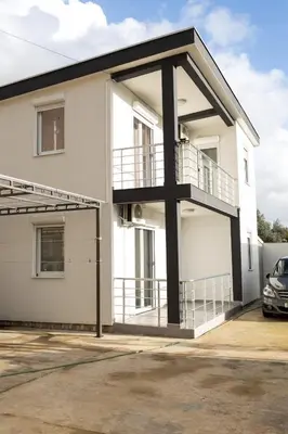 a white house with a balcony at Deutsche Willa in Sutomore