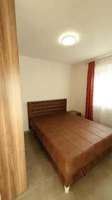 a large bed in a room with a window at Deutsche Willa in Sutomore