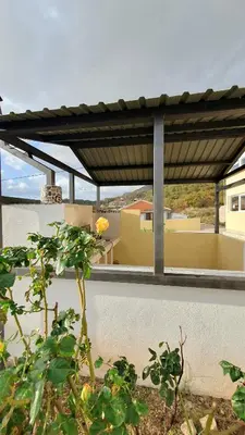 a pergola on a wall with a plant at Deutsche Willa in Sutomore