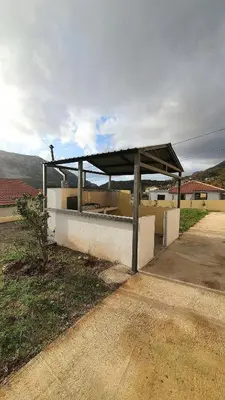 a bus stop with a roof on the side of a road at Deutsche Willa in Sutomore