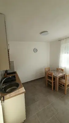 a kitchen with a sink and a table at Deutsche Willa in Sutomore