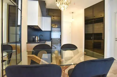 a dining room with a glass table and chairs at Prometheus Apartments in Budva