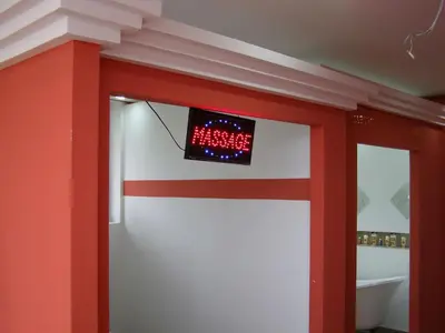 a red and white wall with a clock on it at Hotel Wellness & Spa Angelo Gabriel in Buljarica