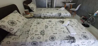 a bed with a comforter with planets andhazard at Cozzy apartment near the Aiport Podgorica in Podgorica
