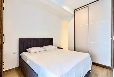 a bedroom with a large bed and a glass door at Montenegro at the Green Stone beach in Budva