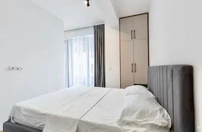 a white bed in a bedroom with a window at Montenegro at the Green Stone beach in Budva