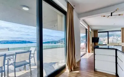a dining room with a table and a large window at The best view in Montenegro in Budva