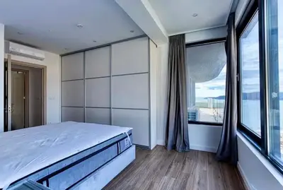 a bedroom with a large bed and a large window at The best view in Montenegro in Budva