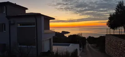 a building with the sunset in the background at Sweet Sea Villa in Utjeha