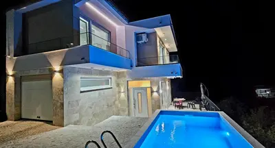 a house with a swimming pool at night at Sweet Sea Villa in Utjeha