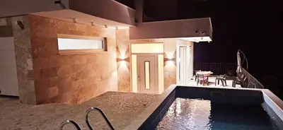 a house with a swimming pool next to a patio at Sweet Sea Villa in Utjeha