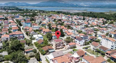 an aerial view of a city with a red marker at Apartments Montenegrina in Ulcinj