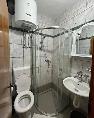 a bathroom with a shower and a toilet and a sink at Apartments Montenegrina in Ulcinj
