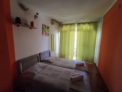 a bedroom with a bed and a green curtain at Apartments Montenegrina in Ulcinj