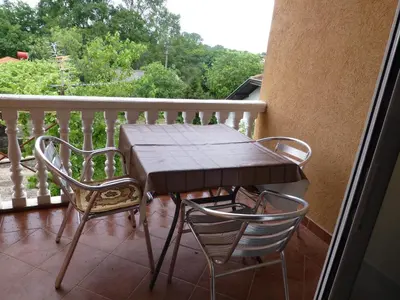 a wooden table and two chairs on a balcony at Apartments Montenegrina in Ulcinj