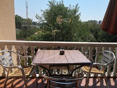 a wooden table and chairs on a balcony at Apartments Montenegrina in Ulcinj