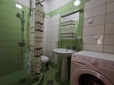 a bathroom with a sink and a washing machine at Apartments Montenegrina in Ulcinj