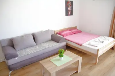 a living room with a couch and a table at Apartments Miki in Bar